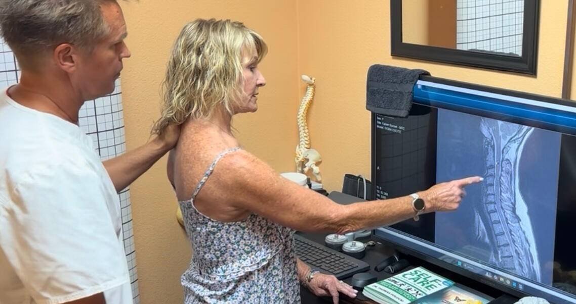 Santa Clarita chiropractor Dr. Thomas Polucki discussing a cervical spine scan with a patient during a consultation