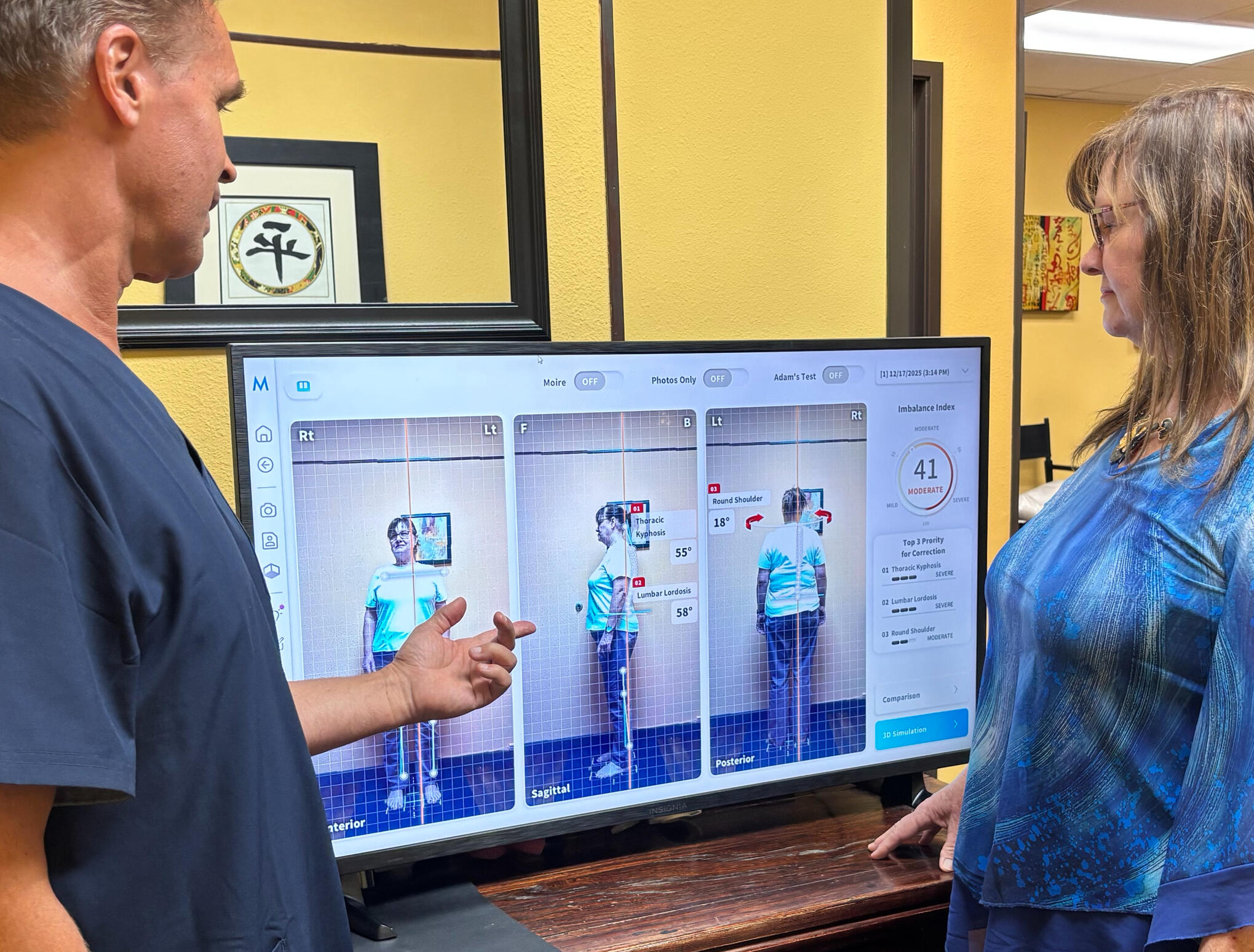 Santa Clarita chiropractor Dr. Thomas Polucki discussing a cervical spine scan with a patient during a consultation