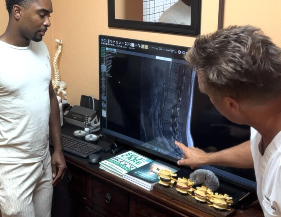 Santa Clarita chiropractor Dr. Thomas Polucki discussing a cervical spine scan with a patient during a consultation