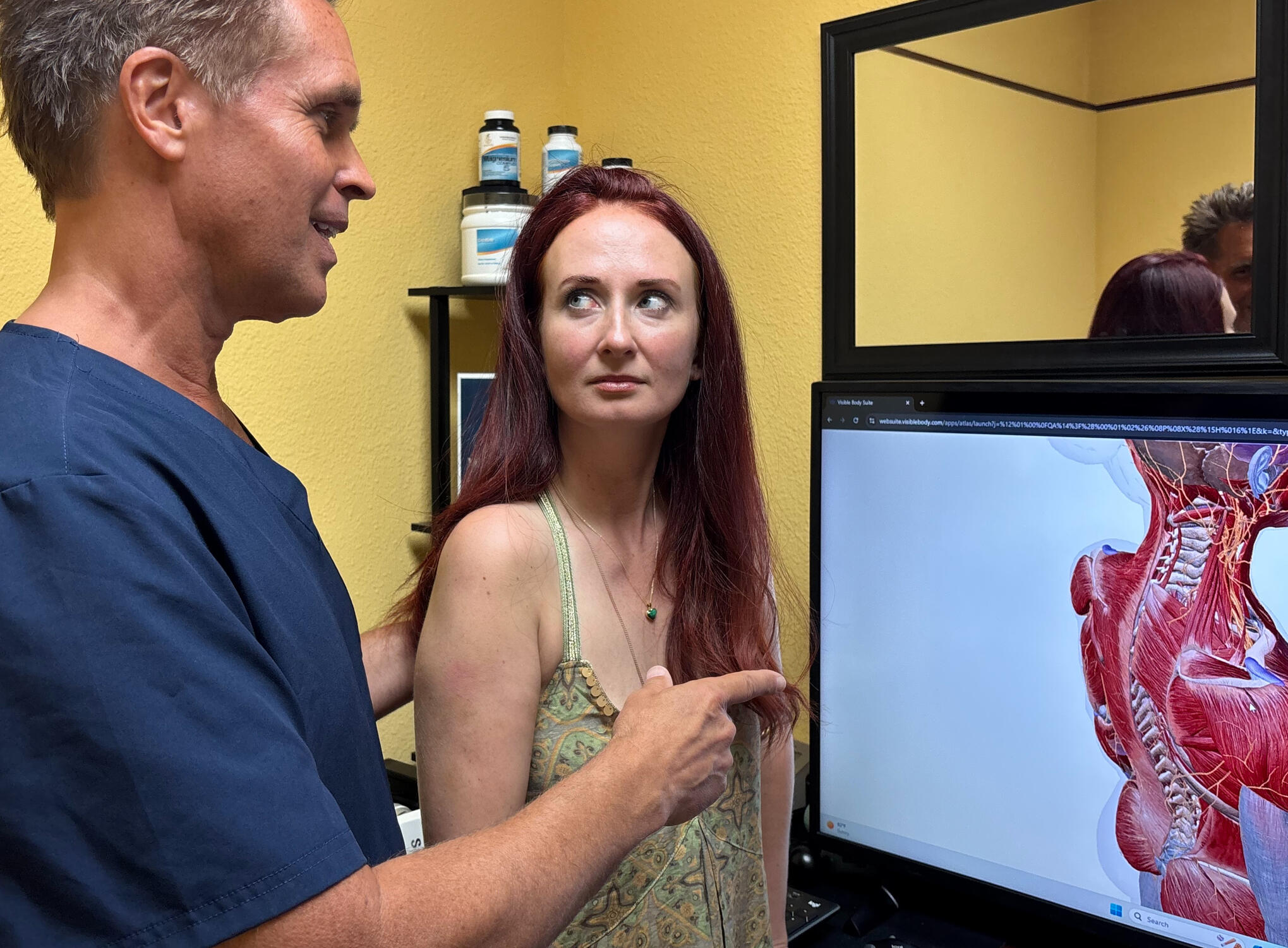 Santa Clarita chiropractor reviewing spine scan with patient Santa Clarita chiropractor Dr. Thomas Polucki discussing cervical spine with a patient during a consultation