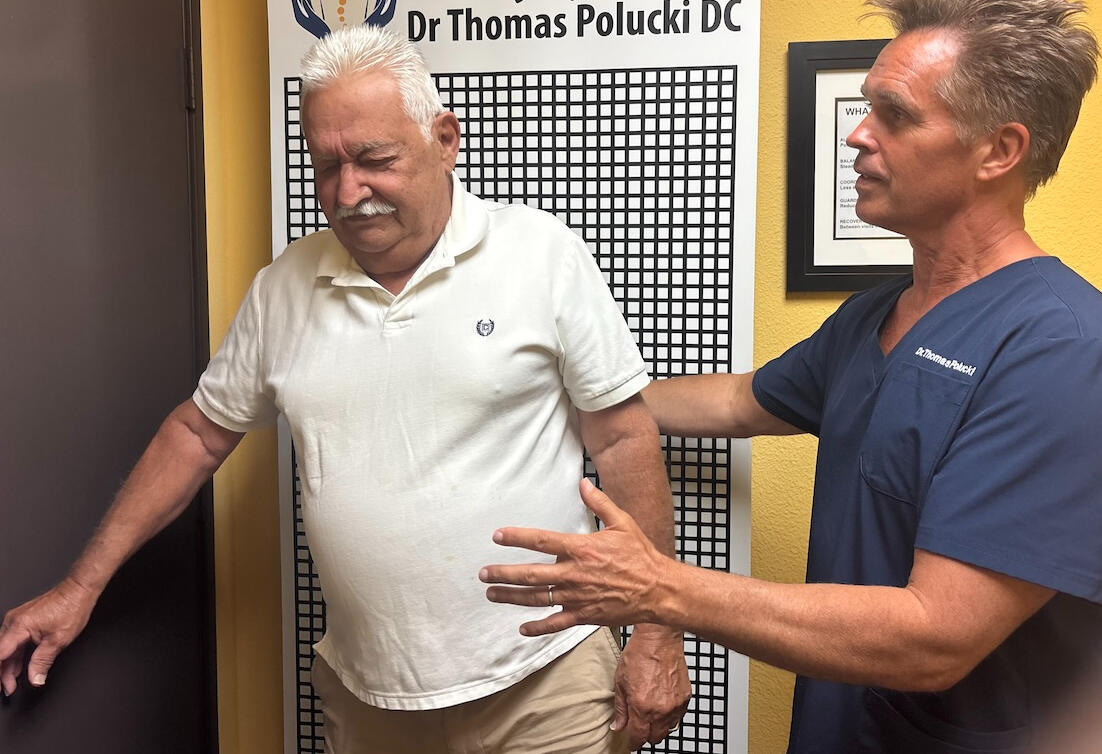 Sciatica exam in Newhall Dr. Thomas Polucki observing balance during a chiropractic visit in Santa Clarita.