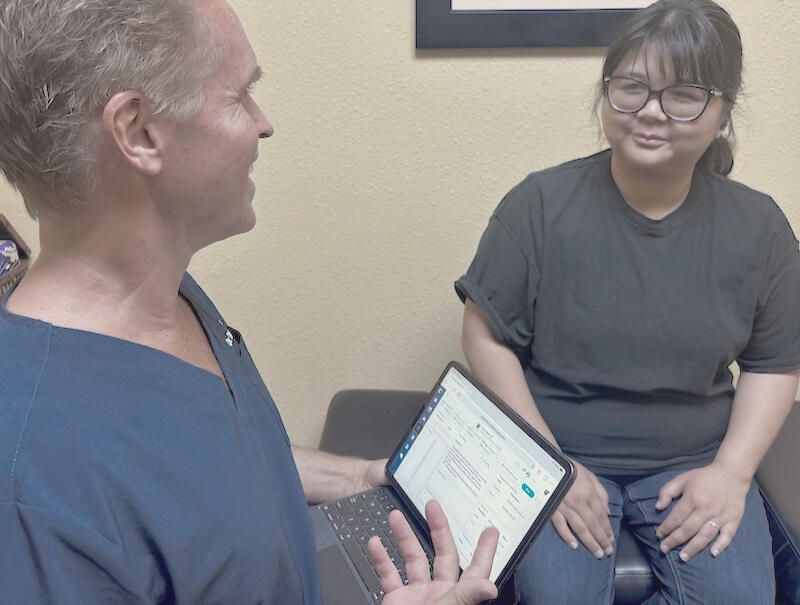 Patient beginning a back pain chiropractic evaluation during a first visit with Dr. Thomas Polucki in Santa Clarita.