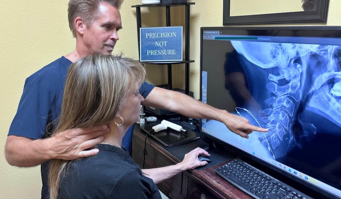 Dr. Thomas Polucki reviewing posture and alignment patterns during a computer-based assessment at a Santa Clarita chiropractic office.